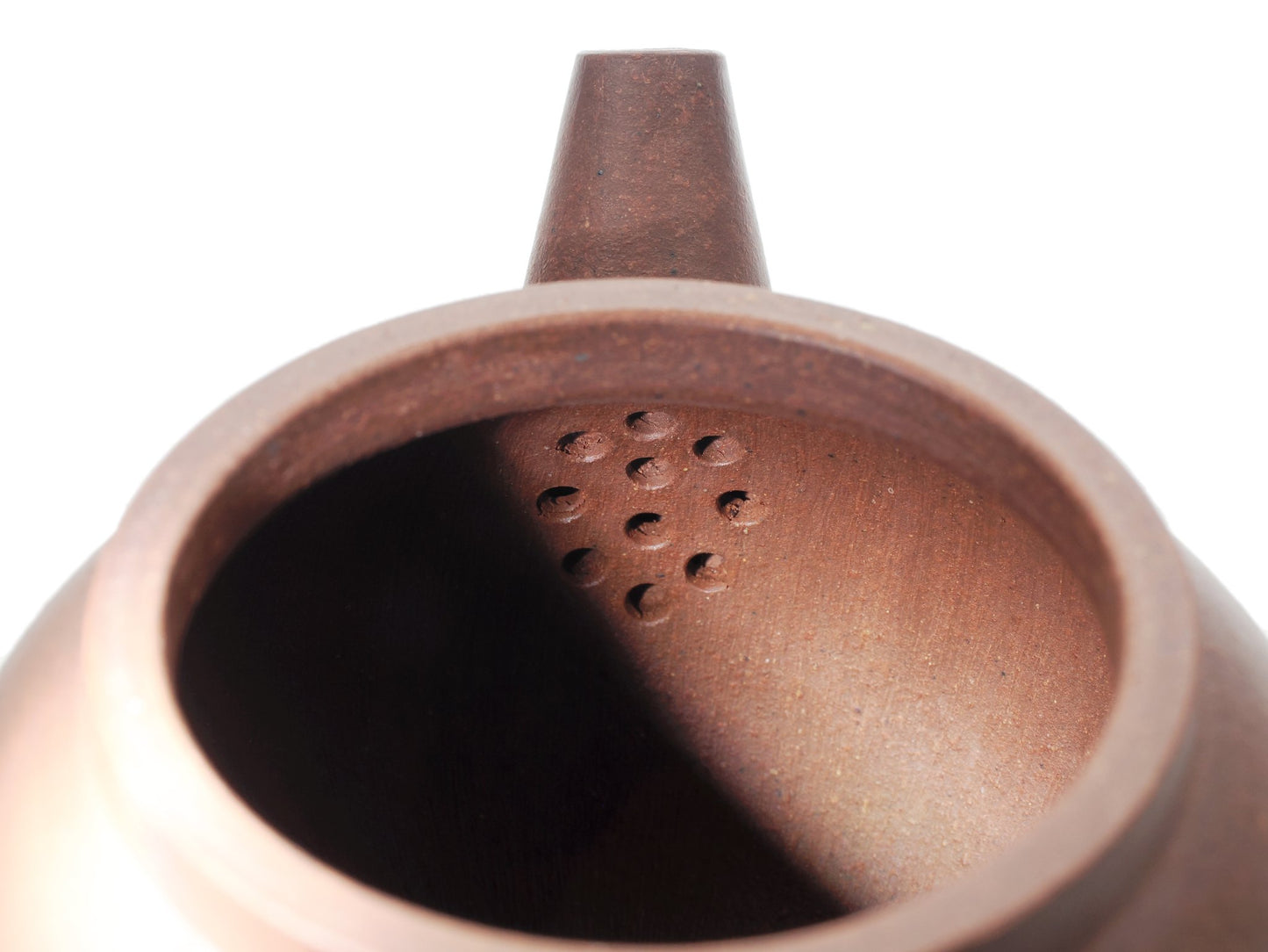 Interior view of the Ju Lun Zhu teapot showing the built‑in multi‑hole filter that keeps leaves out of the cup.