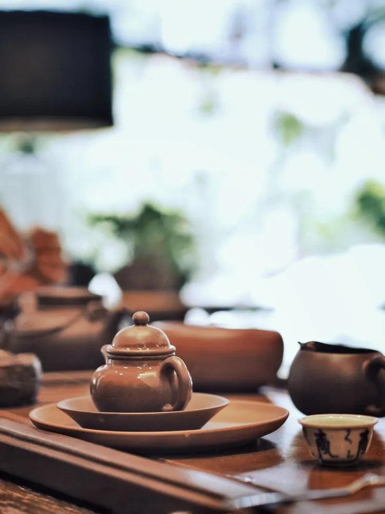 Yixing teapot placed on clay tray at Cha Zhi Ji, capturing a moment of traditional Chinese tea preparation