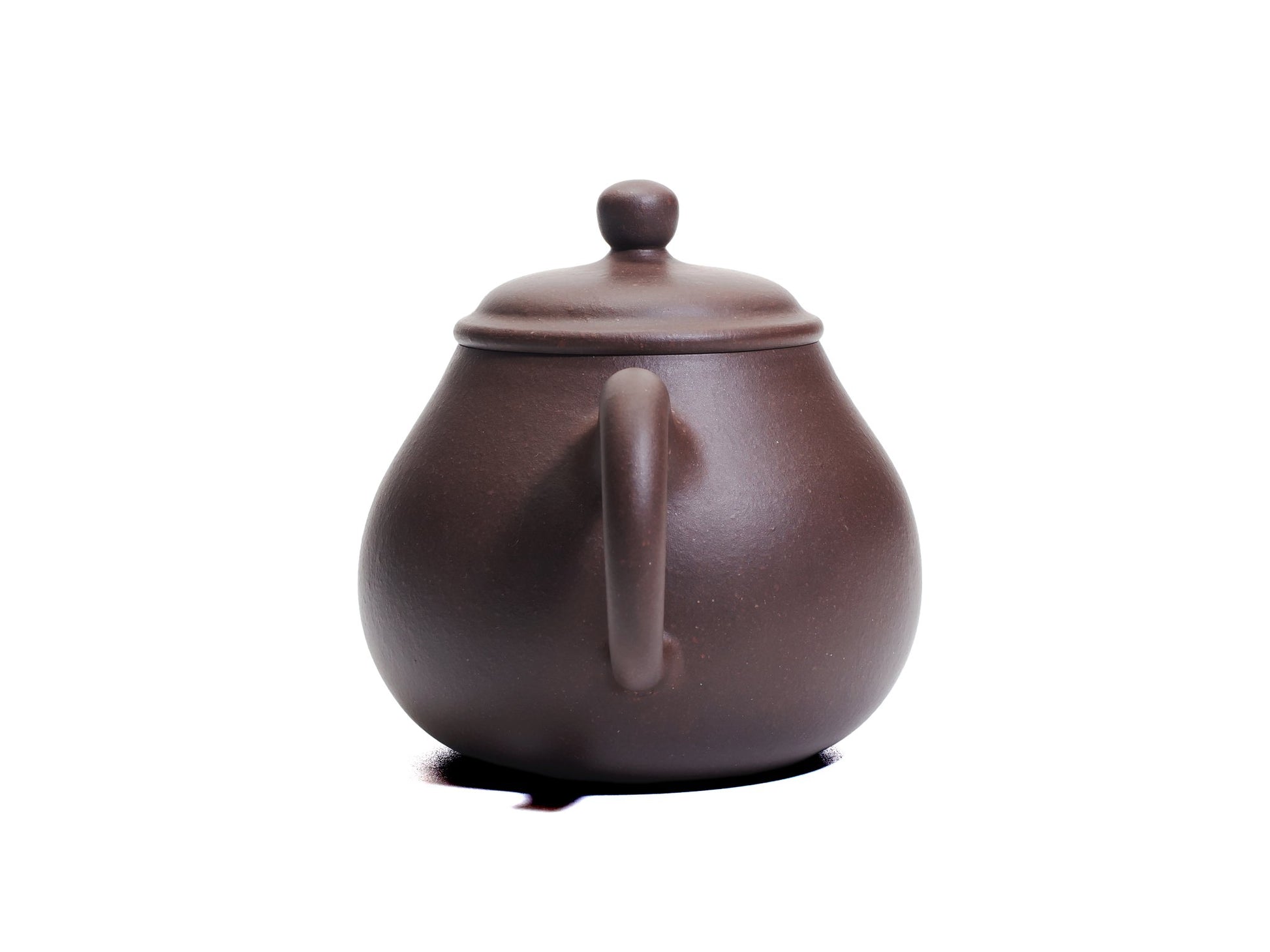 Back view of the Da Ming Yuan Luo Han teapot highlighting the rounded handle and smooth clay surface.