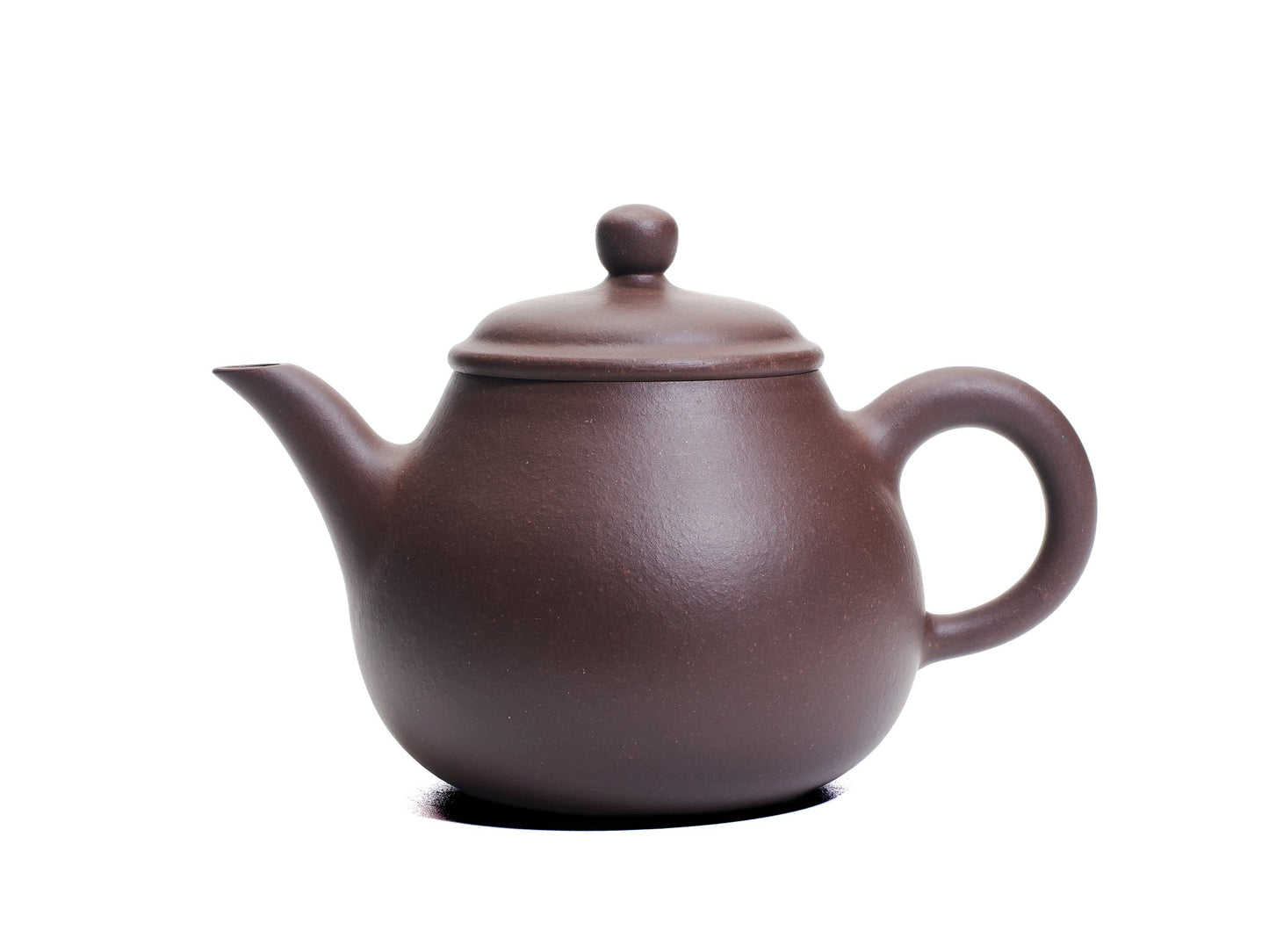 Side view of the Da Ming Yuan Luo Han teapot showing its pear‑shaped bronze‑grade purple clay body, slender spout and round handle.