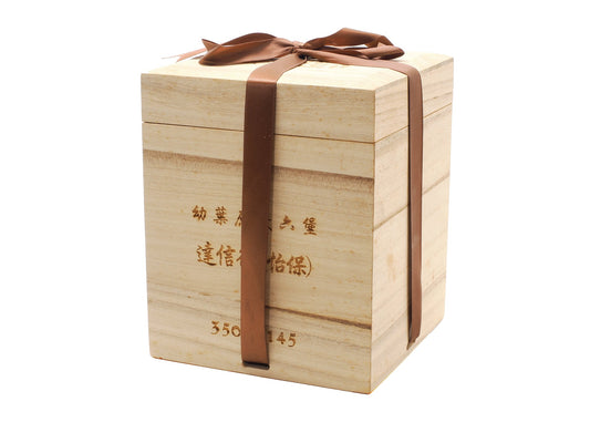 Angled view of Daxinhang Liu Bao tea wooden gift box engraved with Chinese calligraphy
