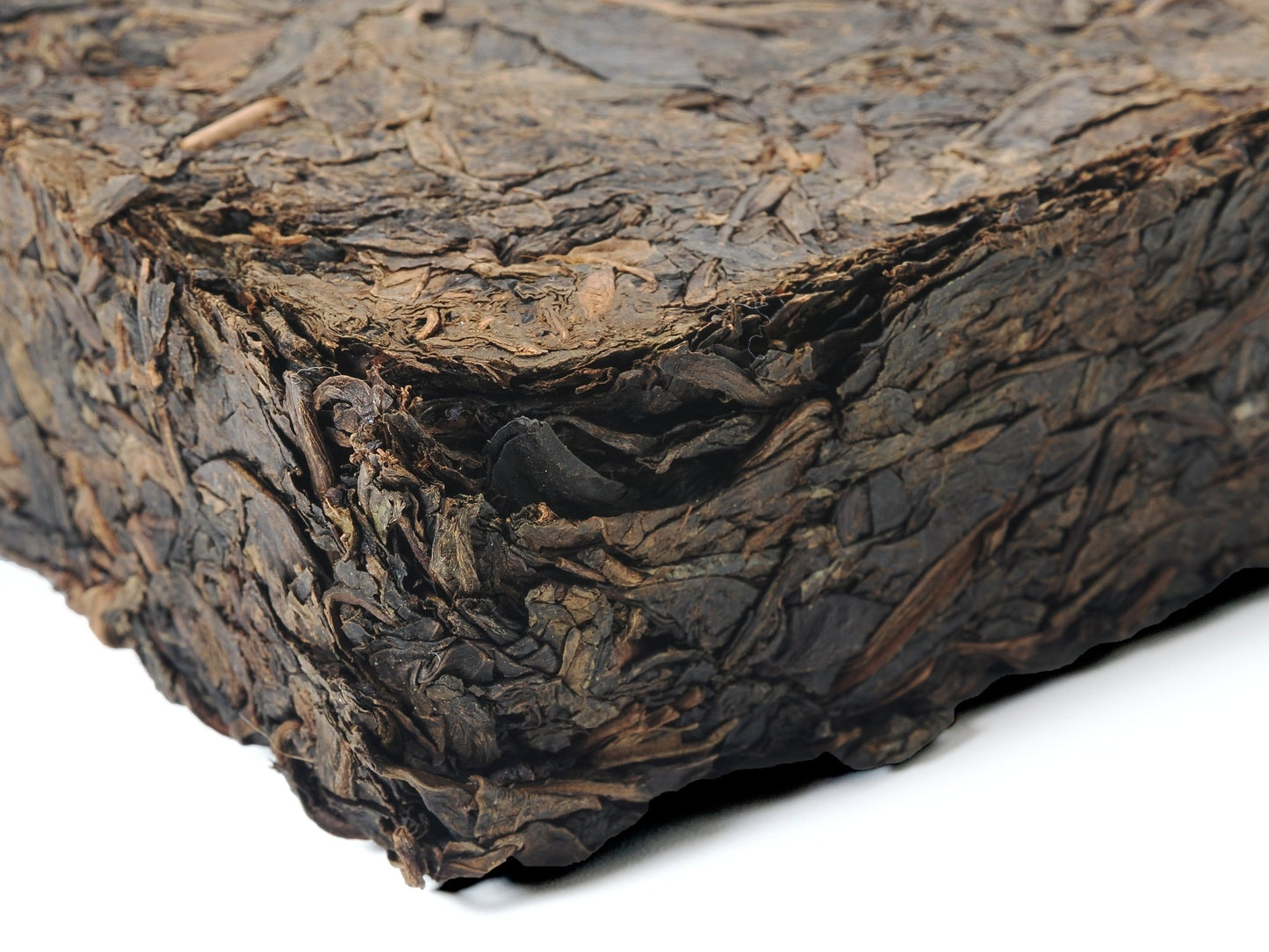 Close-up side view of Fu Brick Tea (茯砖茶) showing compressed leaf texture – traditional dark tea by Cha Zhi Ji and Hui He Tang