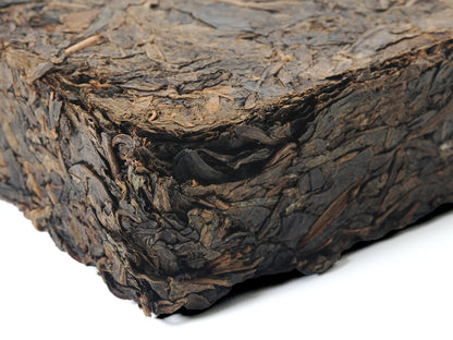 Close-up side view of Fu Brick Tea (茯砖茶) showing compressed leaf texture – traditional dark tea by Cha Zhi Ji and Hui He Tang