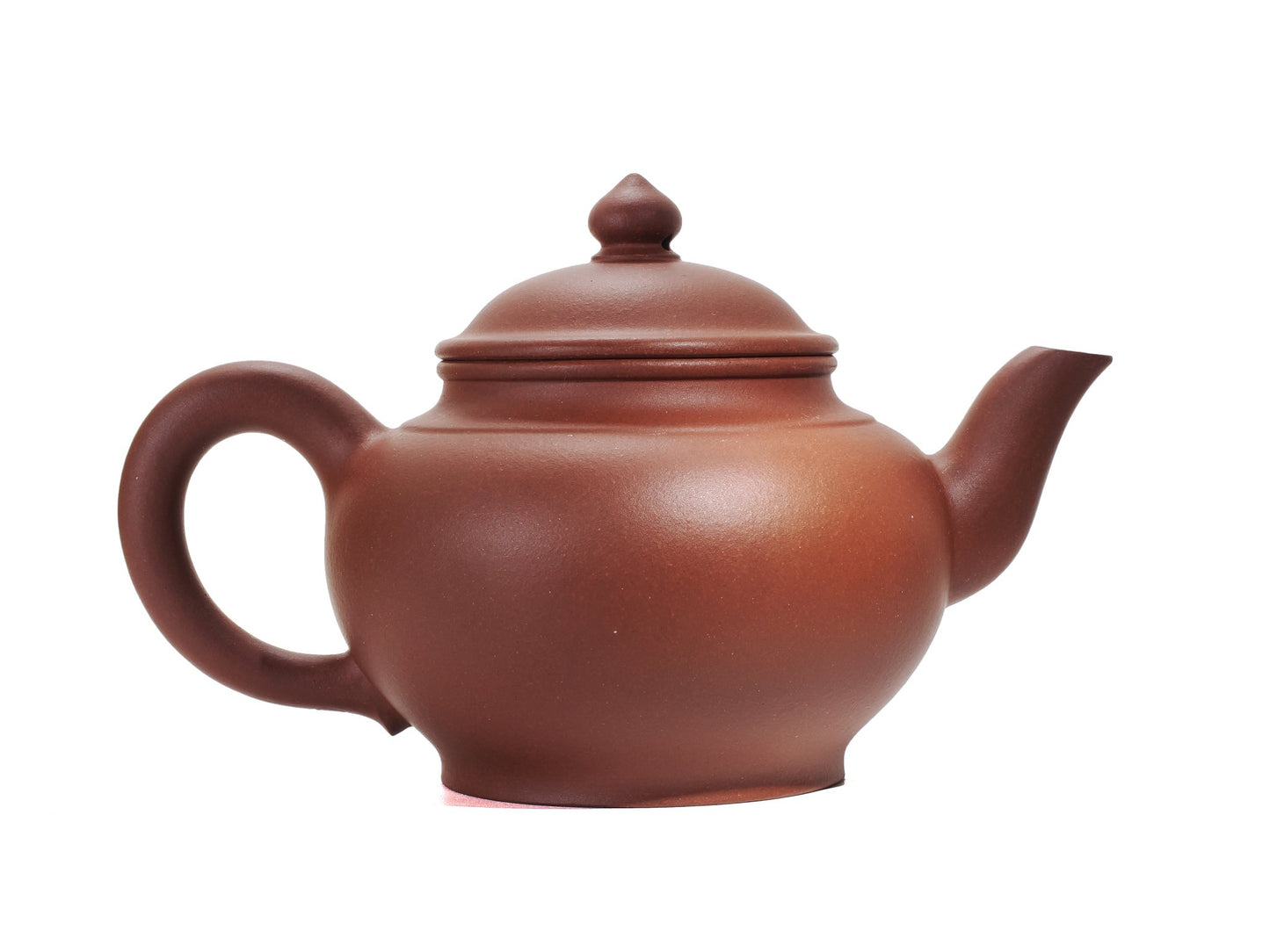 Right side profile of the Hong Pi Long Xiao Ying Hu teapot showing the arched handle and gently curving spout.