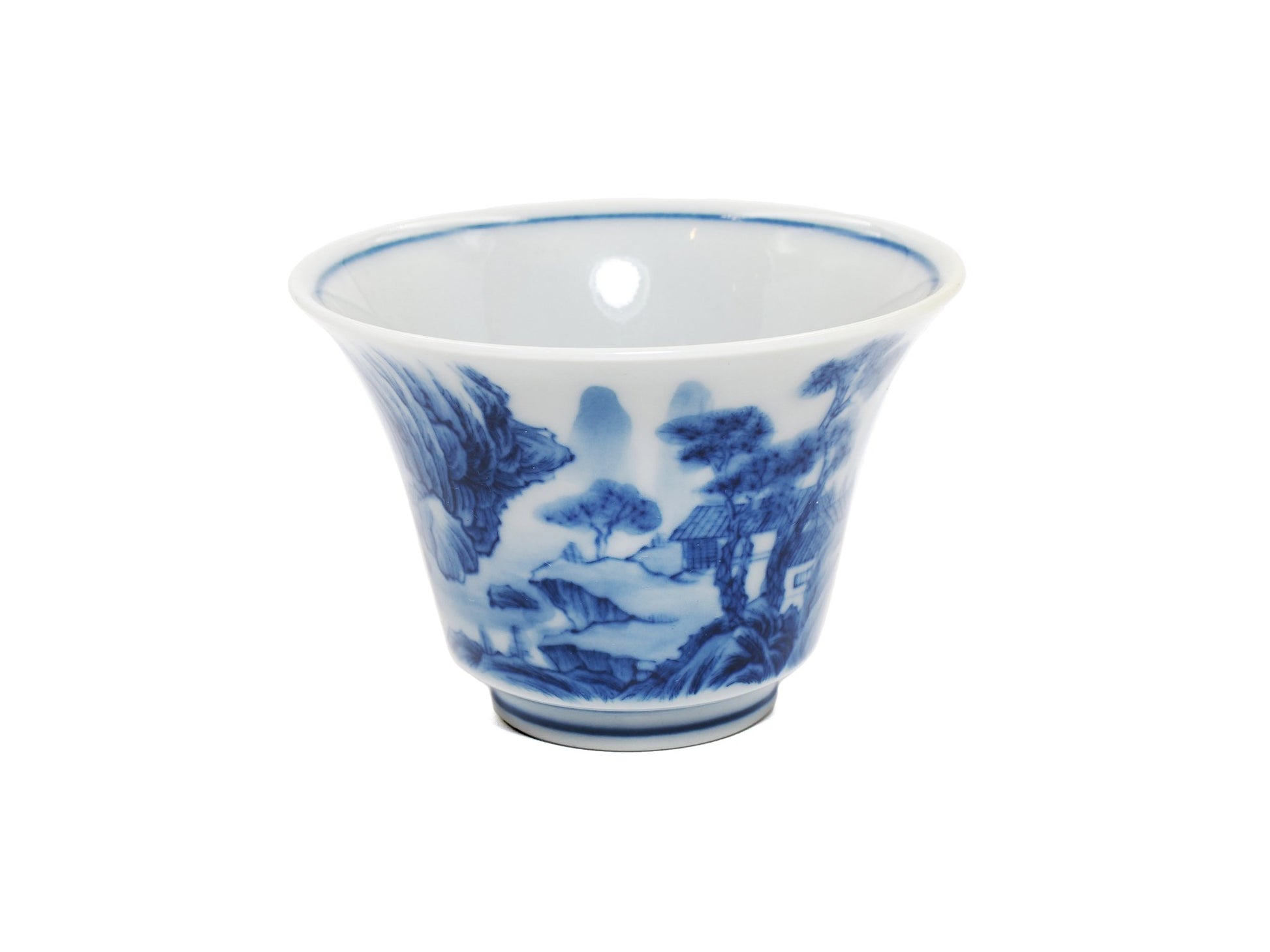 Angled view of hand-painted landscape on modern porcelain teacup