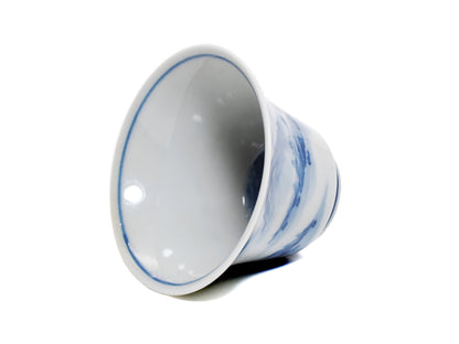 Interior view of modern Jingdezhen teacup, white glaze and blue rim