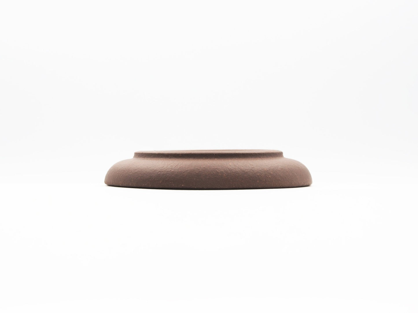 Elevated base view of special grade Lao Zini tea coaster with smooth curve