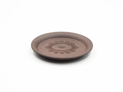 Angled view highlighting the floral engraving on the Yixing tea coaster