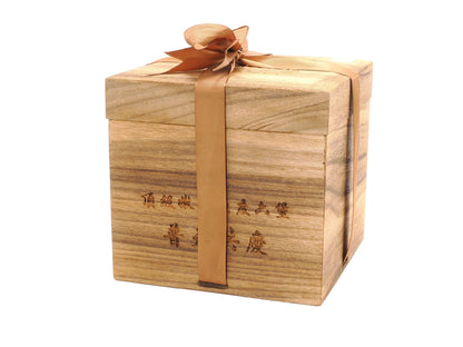 Side view of ribboned wooden box packaging for aged Liu Bao tea