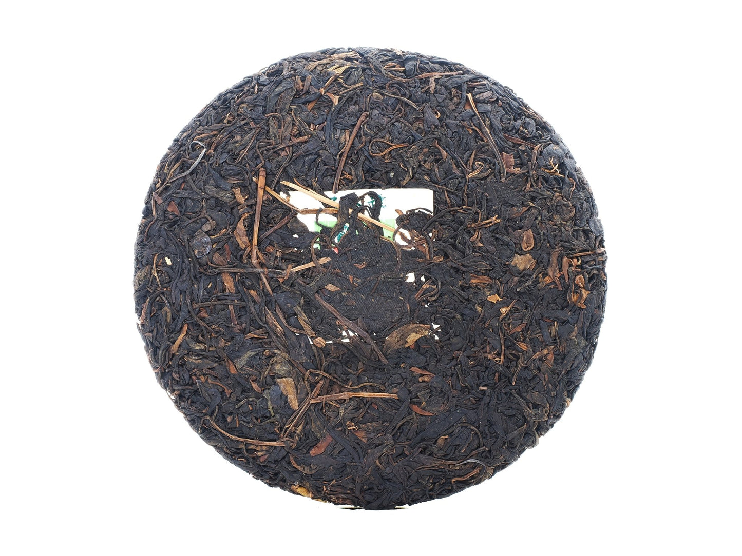 Unwrapped front view of Cha Zhi Ji 2008 Wuliang Gushu Pu-erh Tea Cake with embedded authenticity ticket