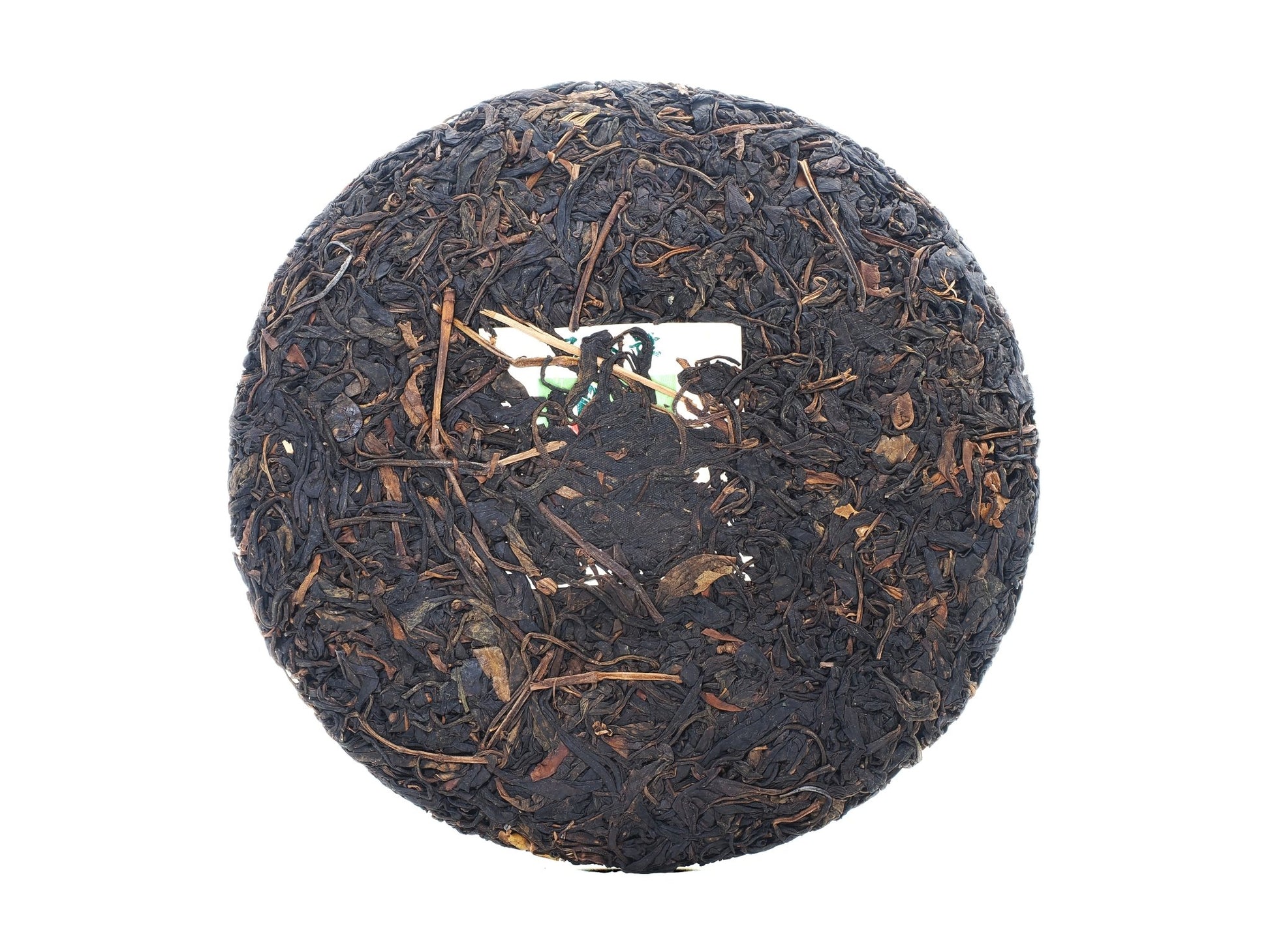 Unwrapped front view of Cha Zhi Ji 2008 Wuliang Gushu Pu-erh Tea Cake with embedded authenticity ticket