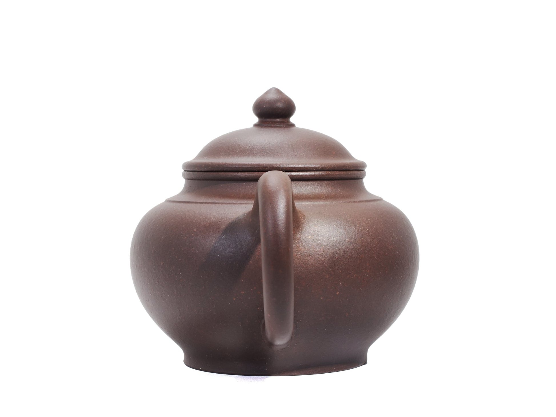 Rear view of the Xiao Ying teapot focusing on the round handle, narrow neck and smooth bronze clay body.