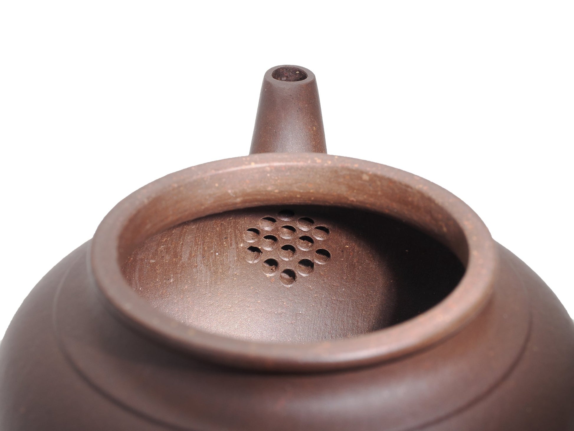 Close‑up of the Xiao Ying teapot’s interior with a built‑in multi‑hole filter near the spout for smooth pouring.