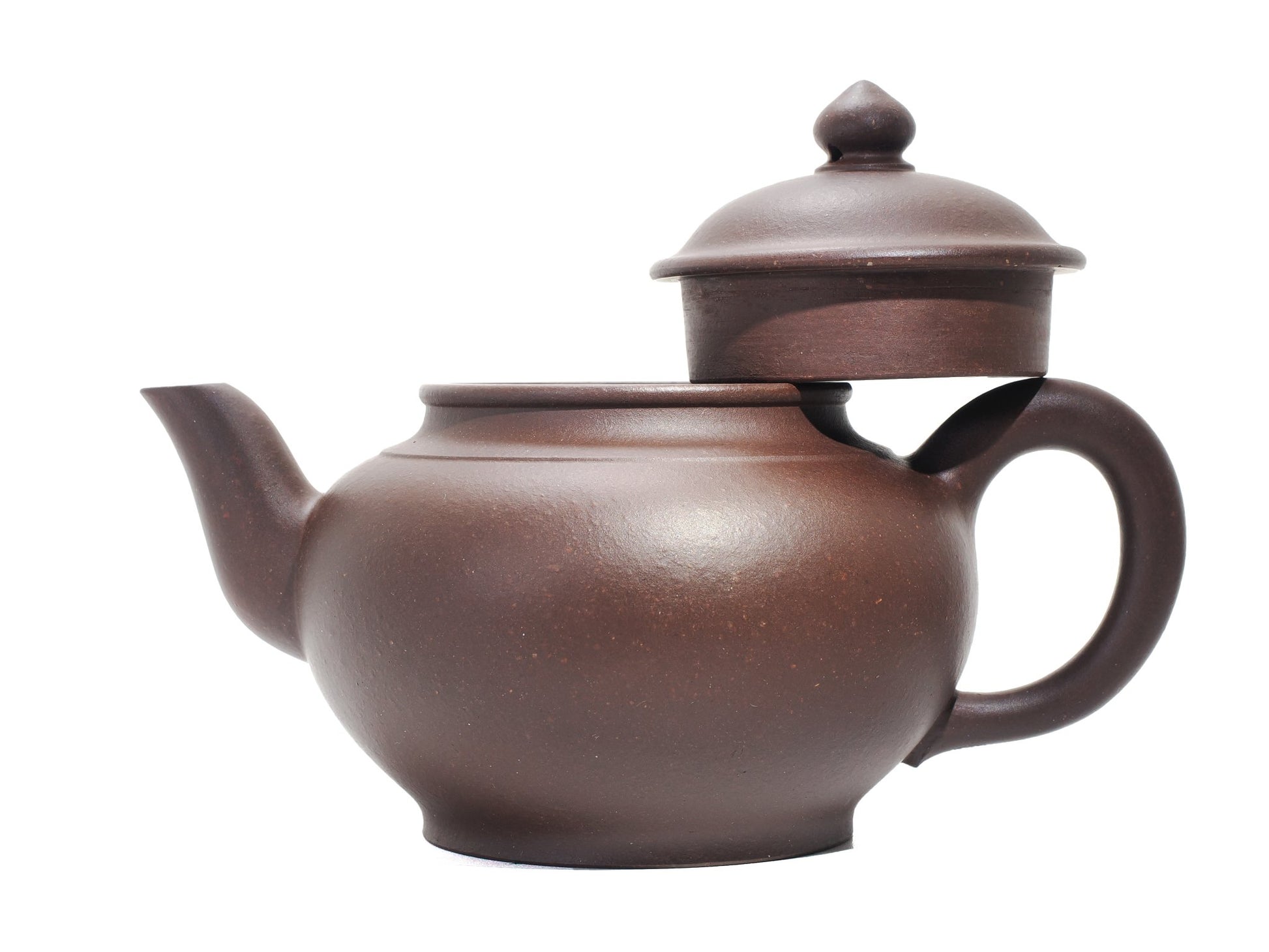 Side view of the Xiao Ying teapot with its lid removed and resting on the handle, highlighting the wide mouth opening and gentle spout curve.