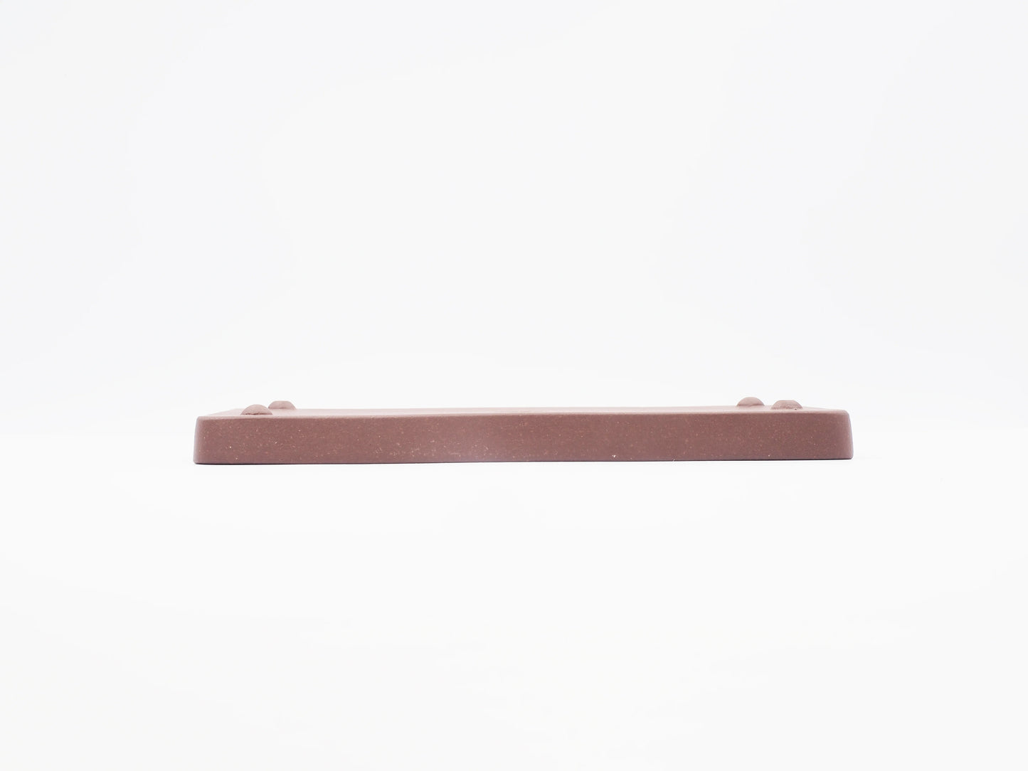 Angled side view of the Yixing clay tea tray's base and feet