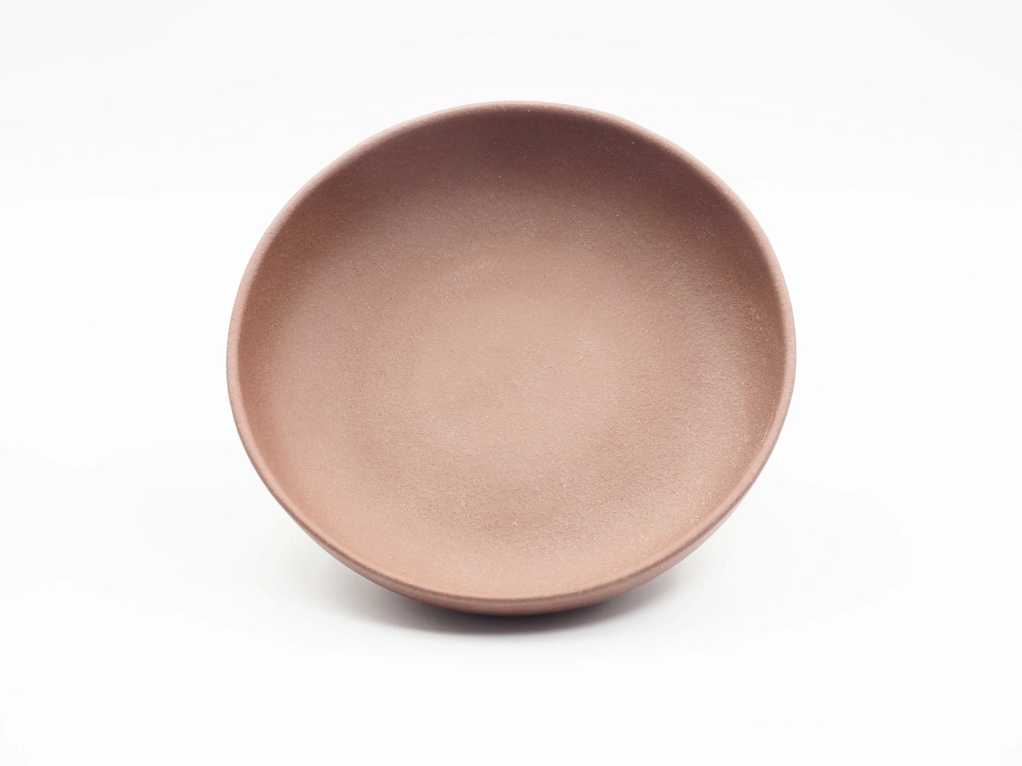 Top-down view of the round Yixing clay tea boat showing its shallow basin