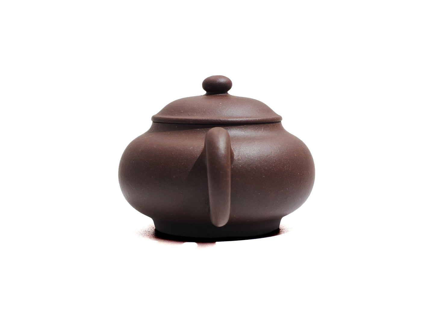 Back handle view of Cha Zhi Ji Junde Yixing teapot in bronze grade purple clay