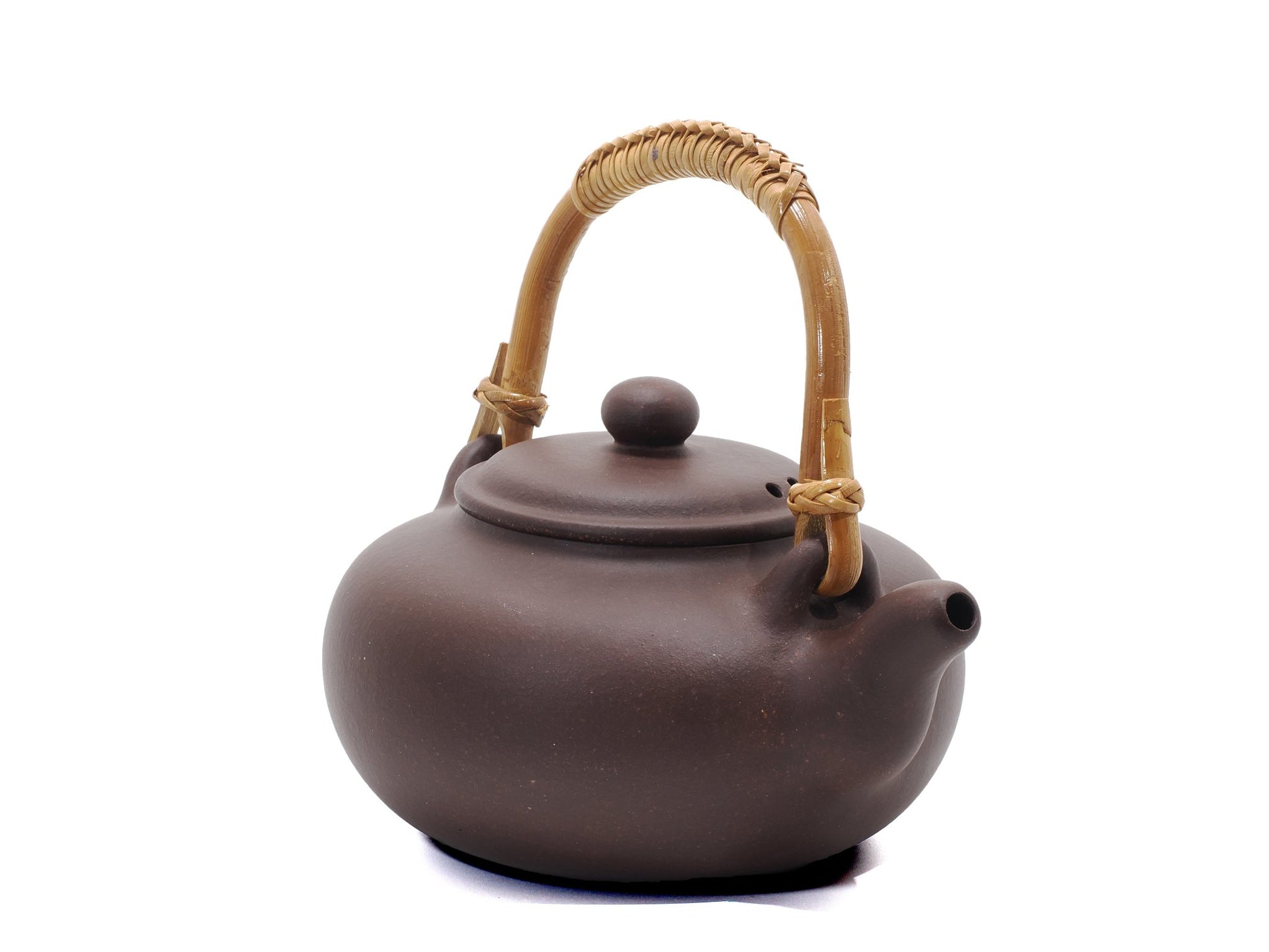 Angled view of teapot showing lid, handle, and spout detail