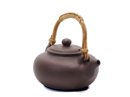 Angled view of teapot showing lid, handle, and spout detail