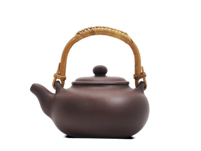 Side profile of Yixing kettle showing rattan handle