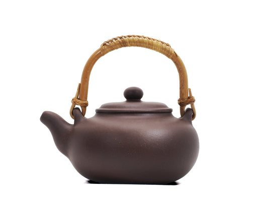 Side profile of Yixing kettle showing rattan handle